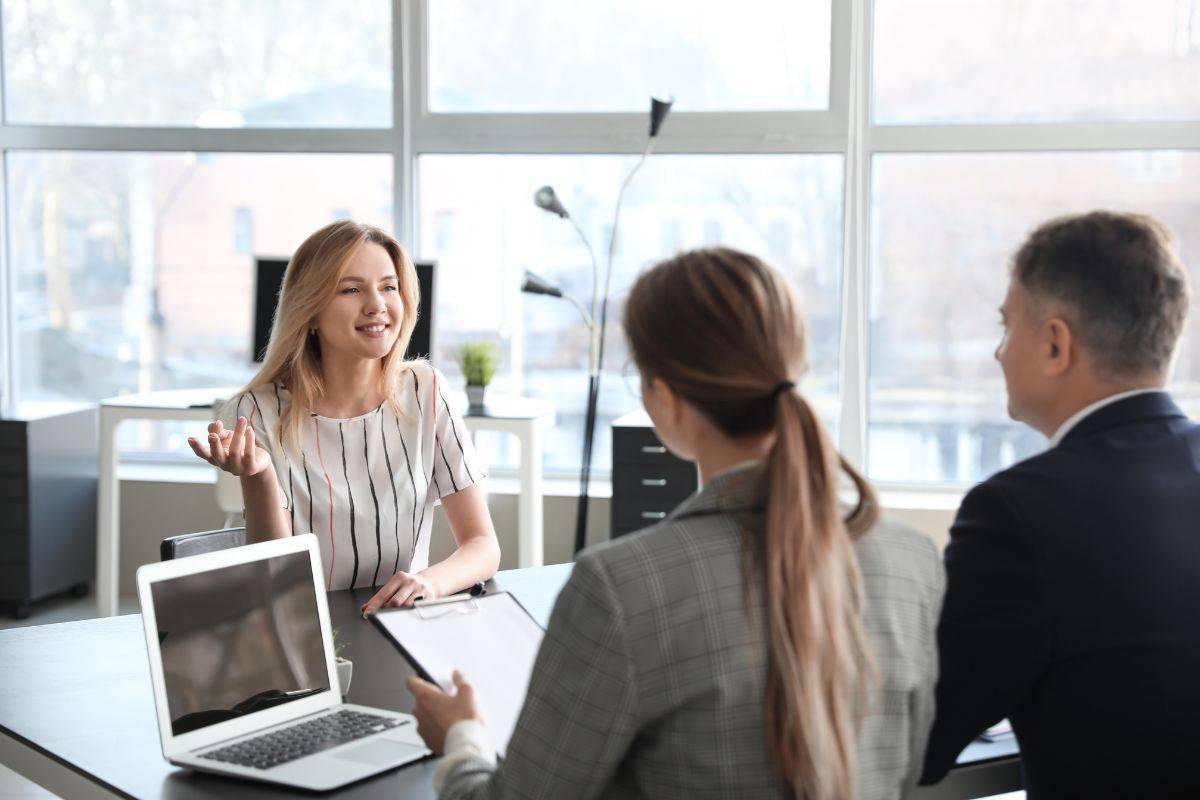 HR professionals in Sydney conducting a job interview, with a candidate discussing experience and career goals in a modern office setting