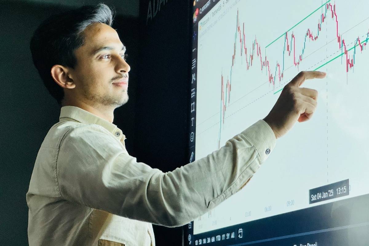 Tradie in Sydney reviewing project performance data on a digital screen, analysing progress and planning site improvements.