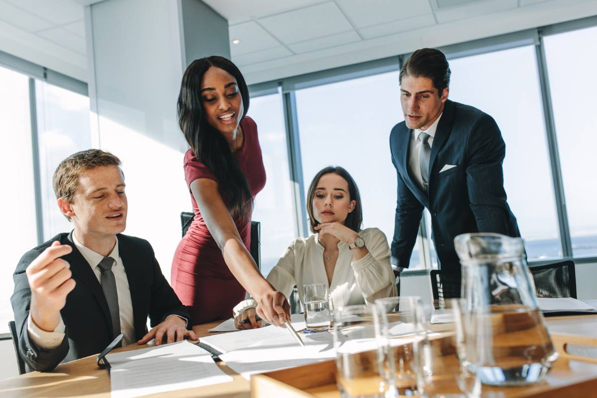 Corporate professionals in Sydney collaborating in a modern boardroom, discussing strategies and business services during a team meeting.